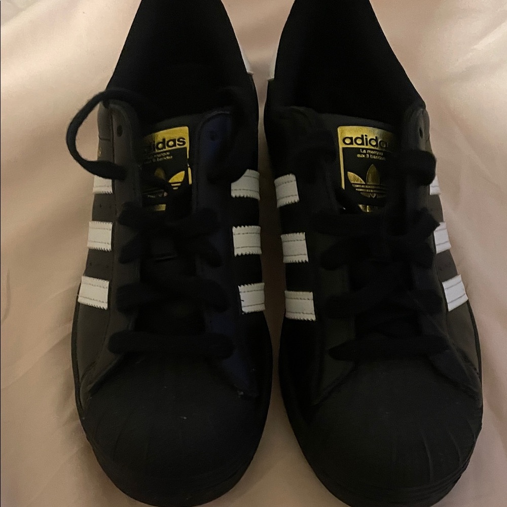 Adidas Black Sneakers with White Stripes and Gold Logo